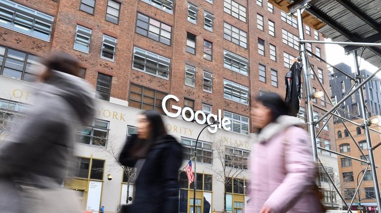 Pedestrians pass the Google building at 111 Eight Ave. in Manhattan...