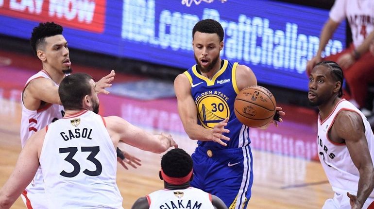 Golden State Warriors guard Stephen Curry (30) is surrounded by...