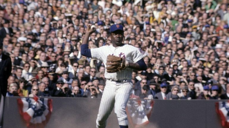 Infielder Ed Charles, No. 5, of the Mets makes a...