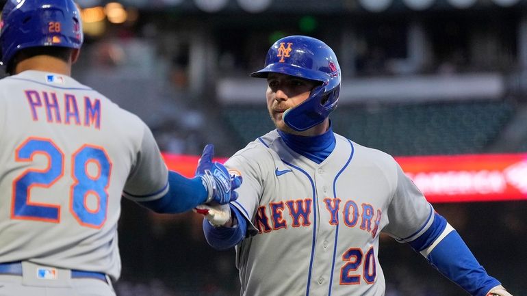 Mets' Pete Alonso, right, is congratulated by Tommy Pham (28)...