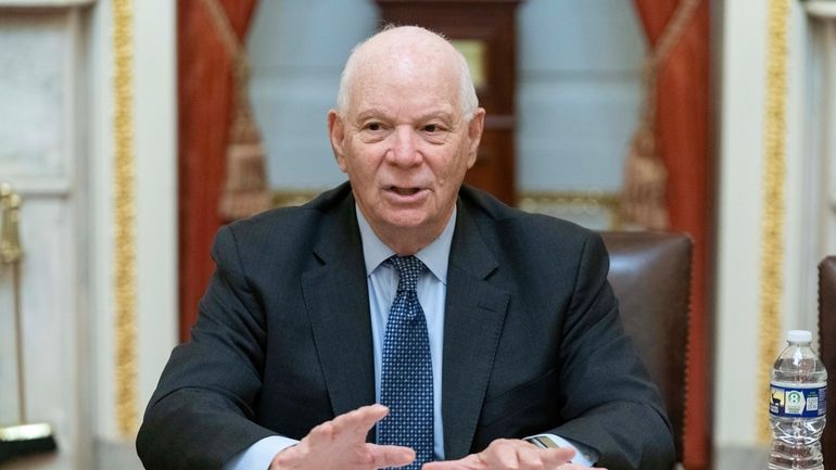 Sen. Ben Cardin, D-Md., talks to reporters as he holds...