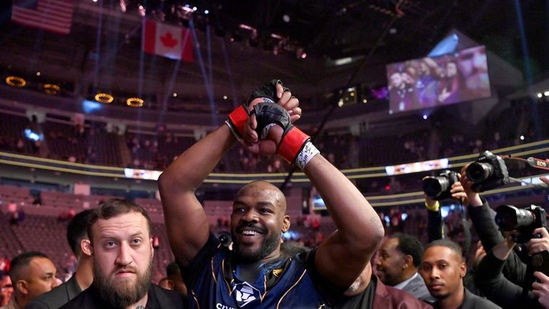 Jon Jones celebrates his victory over Ciryl Gane as he...