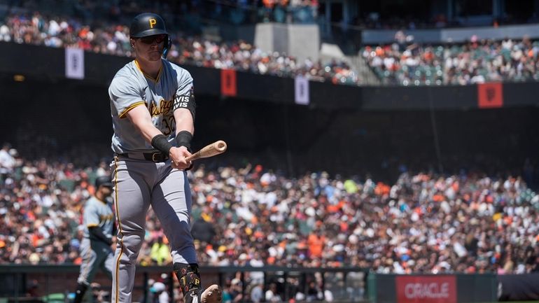 Pittsburgh Pirates' Henry Davis walks to the dugout after striking...