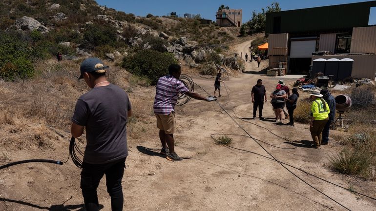 Attendees pull damaged fiber optic cables during the Tribal Broadband...