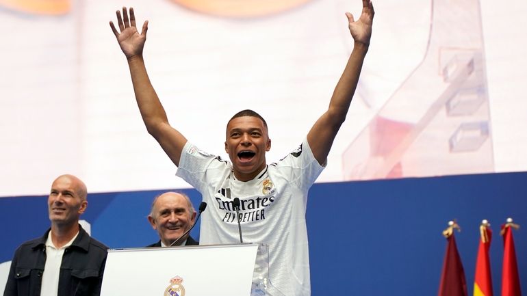 Kylian Mbappe, of France, gestures as he is presented to...