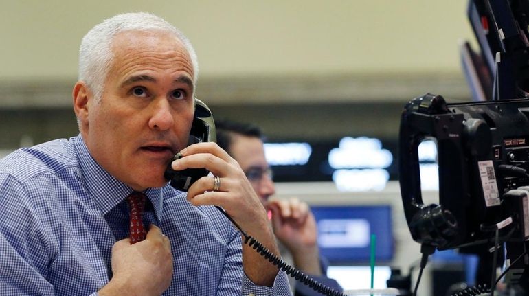 A trader works at the New York Stock Exchange on...