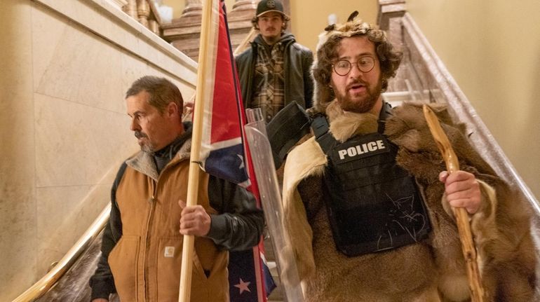 Supporters of President Donald Trump, including Aaron Mostofsky, right, walk...