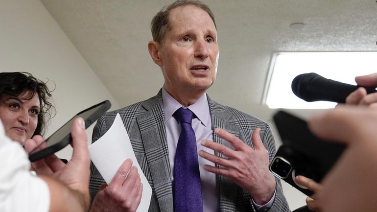 Sen. Ron Wyden, D-Ore., speaks with reporters at the U.S....