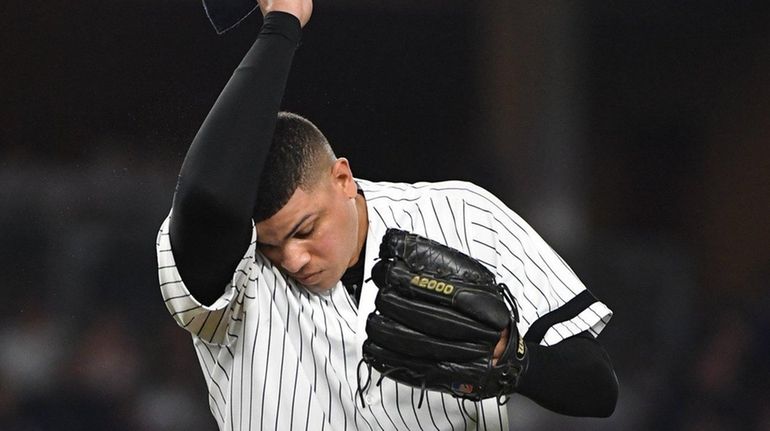 Yankees relief pitcher Dellin Betances reacts during the eighth inning...