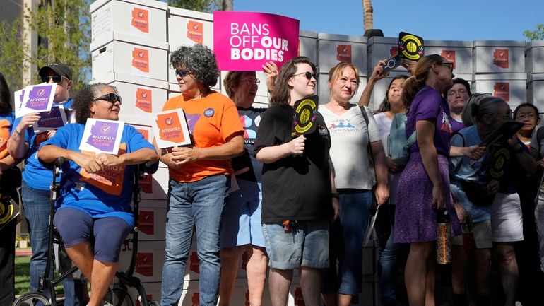 Arizona abortion-rights supporters gather for a news conference prior to...