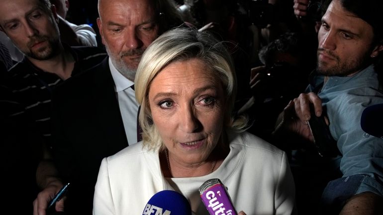 Far-right National Rally party leader Marine Le Pen answers reporters...