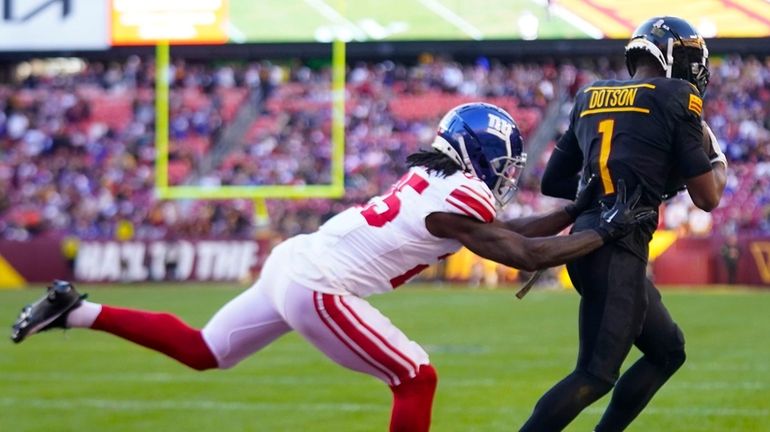 Commanders wide receiver Jahan Dotson scores a touchdown against Giants cornerback Deonte...