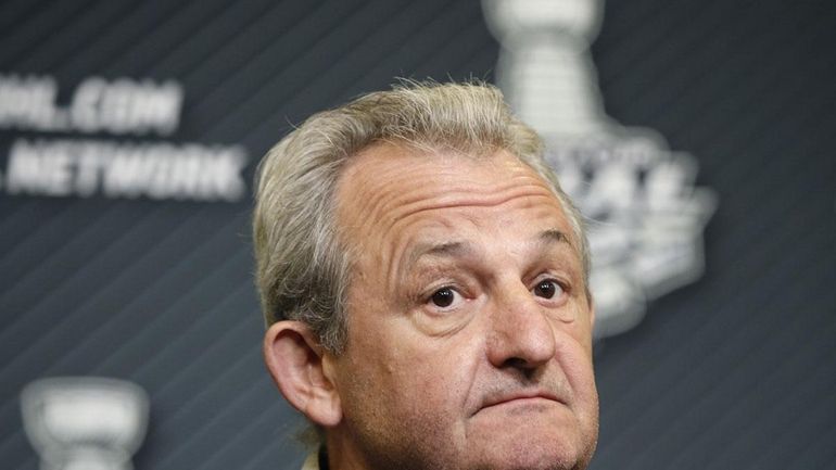 Los Angeles Kings head coach Darryl Sutter listens to a...