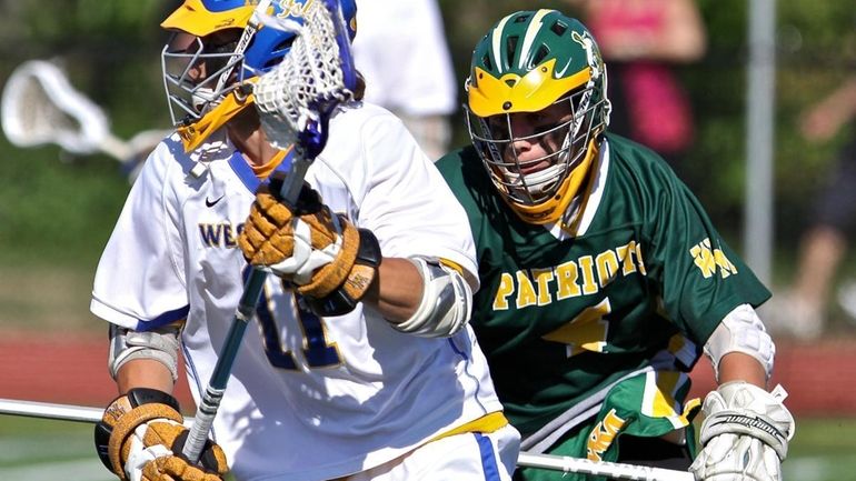 West Islip's Andrew Hodgson #11 moves the ball around the...