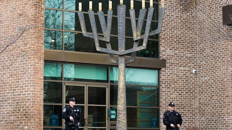 Nassau County police officers stand watch at the Young Israel...