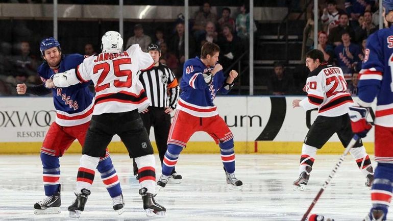 Brandon Prust #8 of the New York Rangers fights Cam...