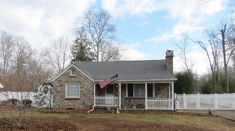 This two-story Mastic Beach Cape with a sizable backyard and...