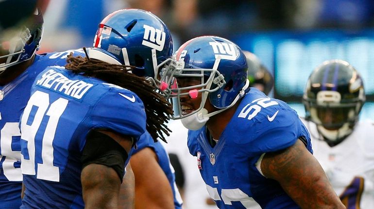 Jonathan Casillas #52 of the New York Giants celebrates a...