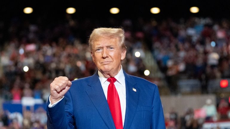 Republican presidential nominee former President Donald Trump pumps his fist...