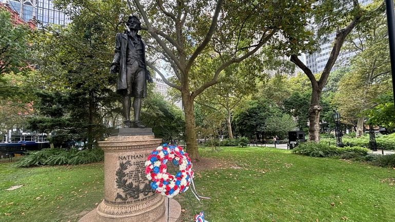 A statue of patriot Nathan Hale, who was caught spying...