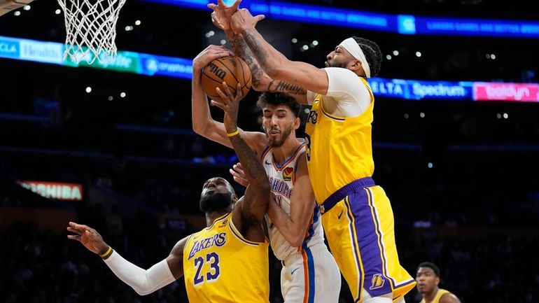 Oklahoma City Thunder forward Chet Holmgren, center, works for a...