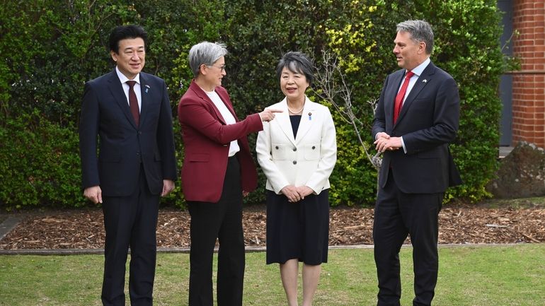 Japanese Defense Minister Minoru Kihara, left, Australian Foreign Minister Penny...