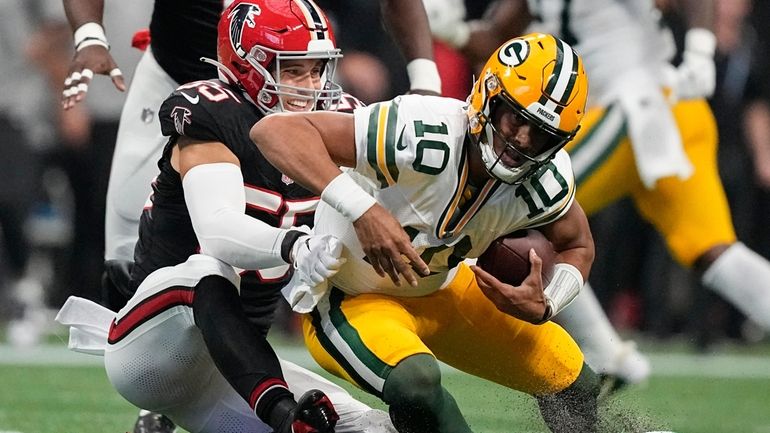 Atlanta Falcons linebacker Kaden Elliss (55) sacks Green Bay Packers...