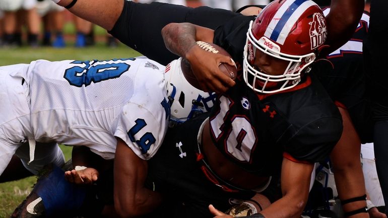 Bellport RB Donte Phillips powers his way over the goal...