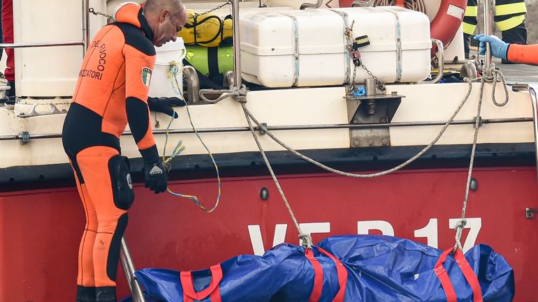 Italian firefighter divers bring ashore in a plastic bag the...