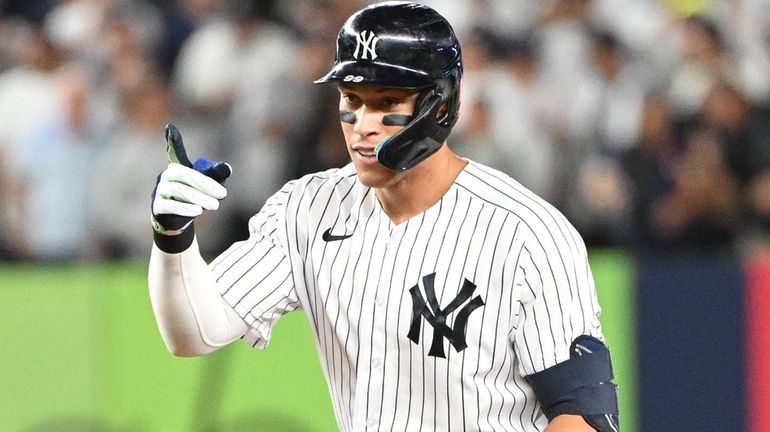 TheYankees' Aaron Judge gestures from second base after his double...