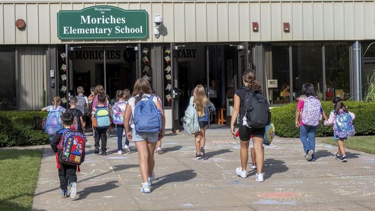 Students arrive for the first day of classes Thursday at Moriches...