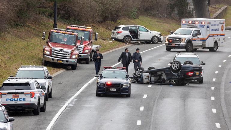 Police investigate at the scene of the crash on Friday...