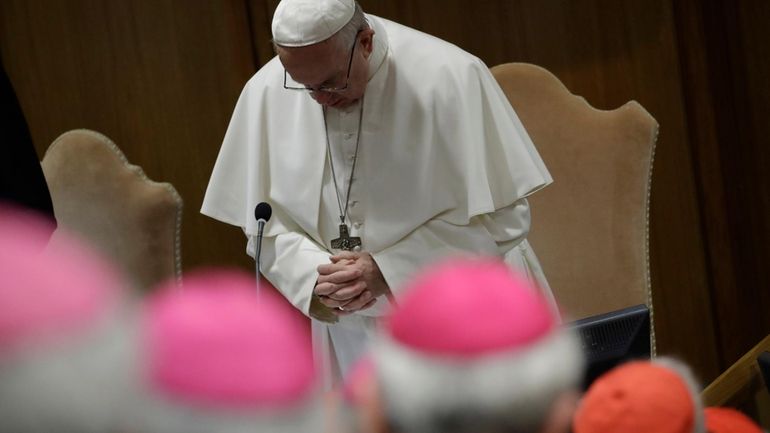 Pope Francis prays at the beginning of the third day...