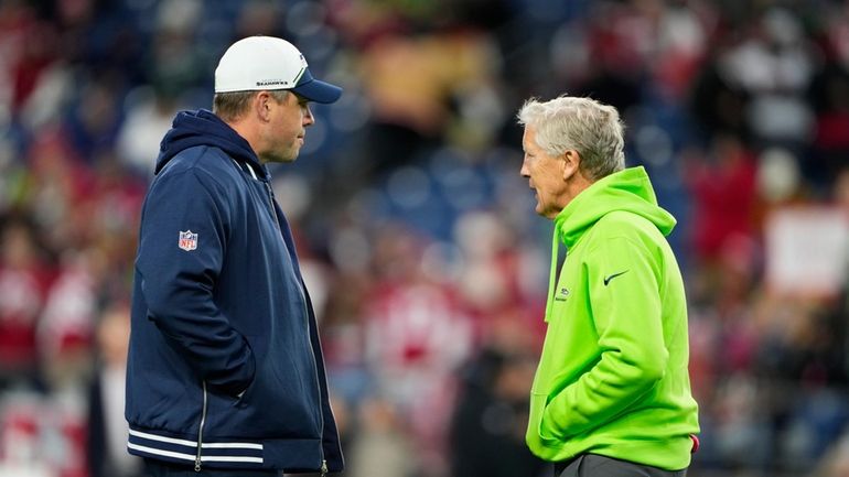 Seattle Seahawks offensive coordinator Shane Waldron, left, talks with head...