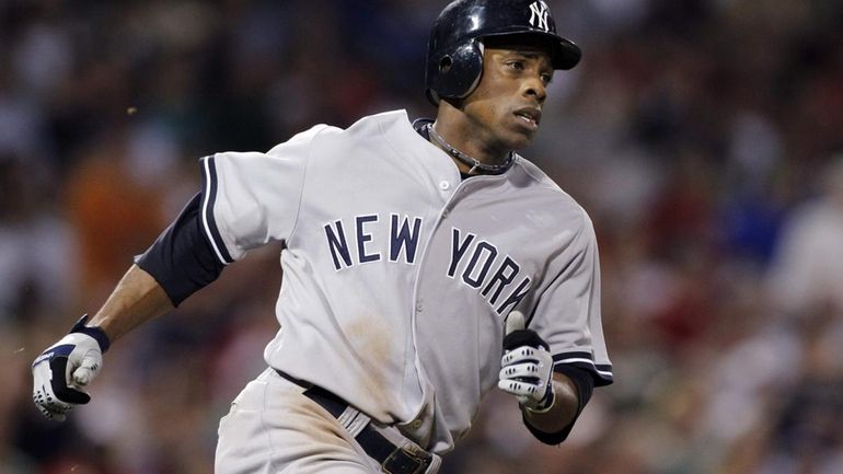 New York Yankees' Curtis Granderson runs up the first base...