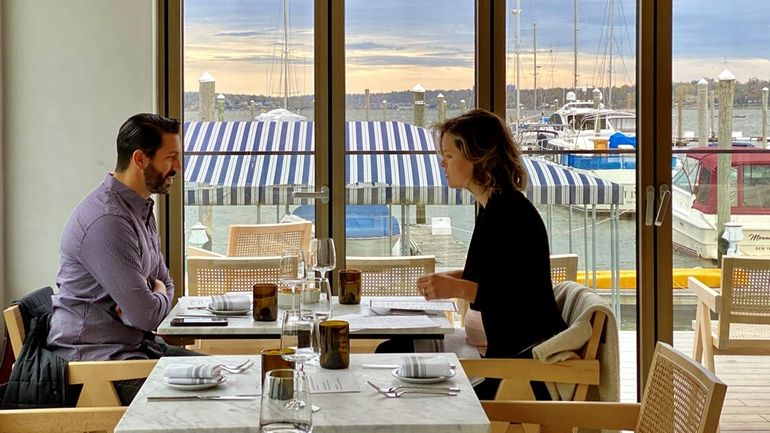 Tables overlook the Safe Harbor Capri marina at Nino's Beach...