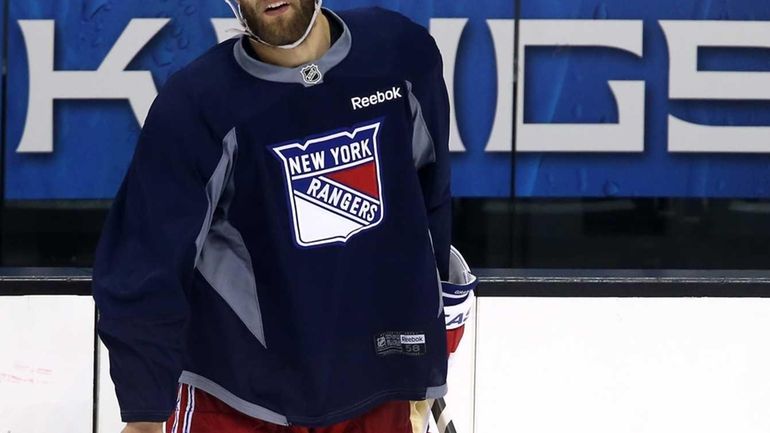 Dan Girardi of the Rangers looks on during a practice...