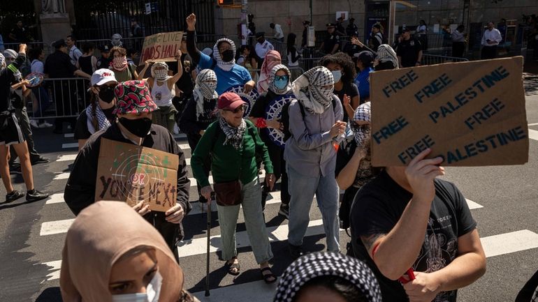 Pro-Palestinian supporters march to Barnard College during the picket line...