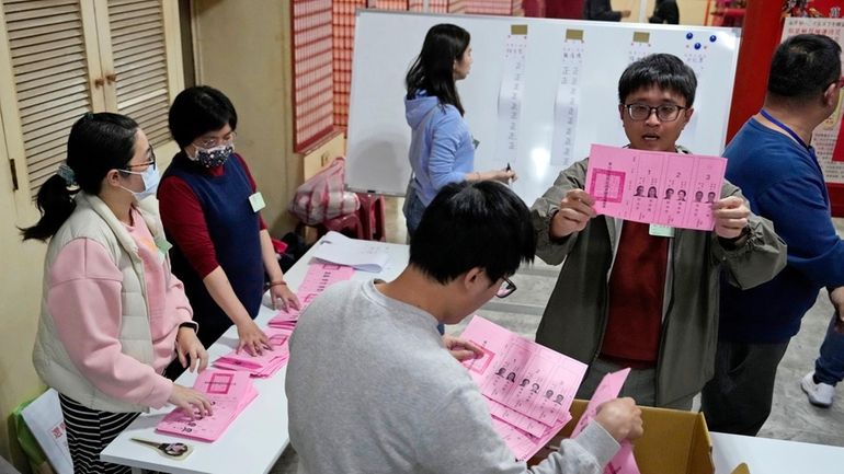 Polling officers count votes in New Taipei City, Taiwan, Jan....