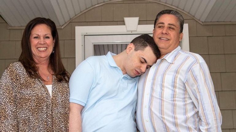 Casey Lang, center, with his father, Randy, right, and stepmother,...