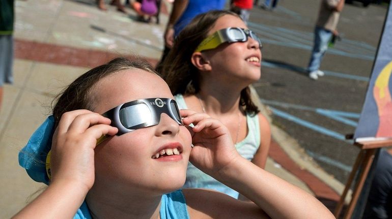 Alexa Steinvurzel, 7, of Roslyn, left, and her sister Rebecca,...