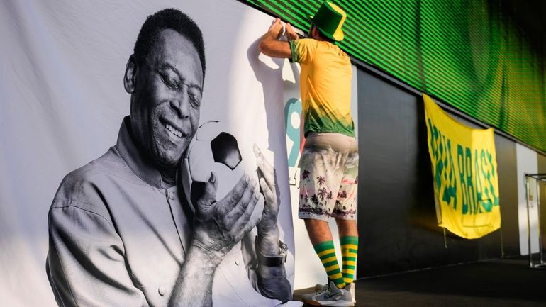 A fan displays a sign in support of Pelé at...