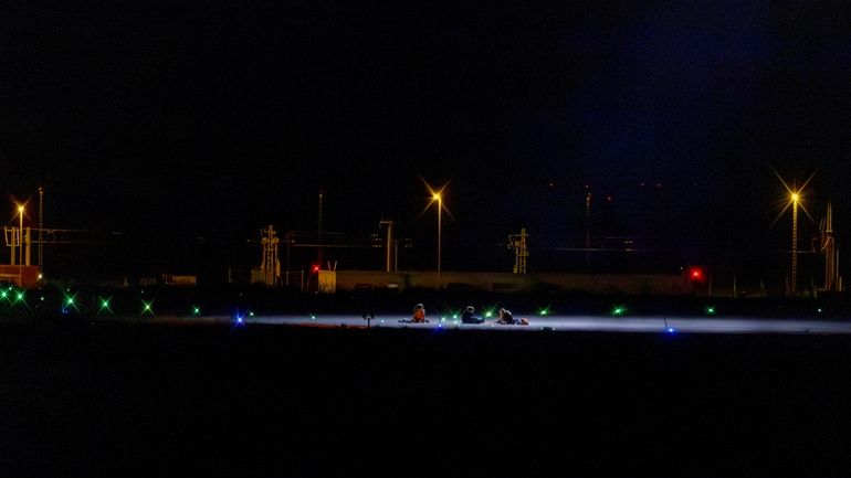 Climate activists sit on a tarmac at Leipzig-Halle Airport in...