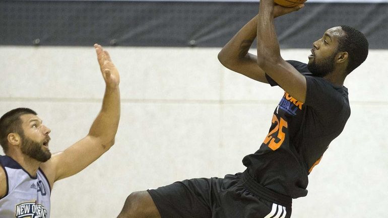 Knicks forward C.J. Leslie, left, shoots against New Orleans Pelicans...