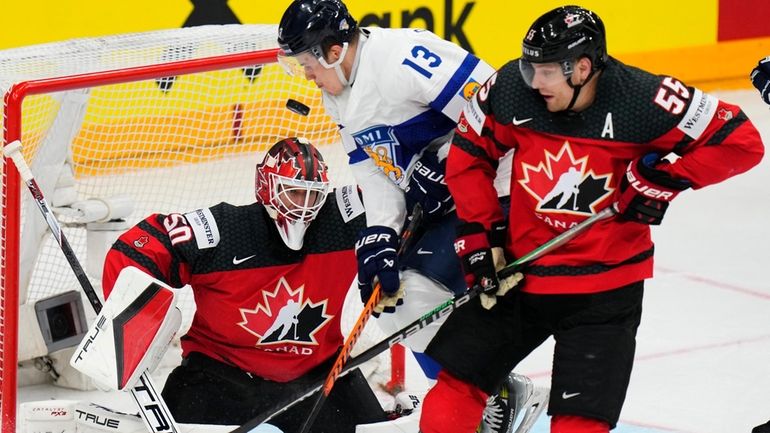 Canada's goalkeeper Jordan Binnington, left, and Canada's Colton Parayko, right,...