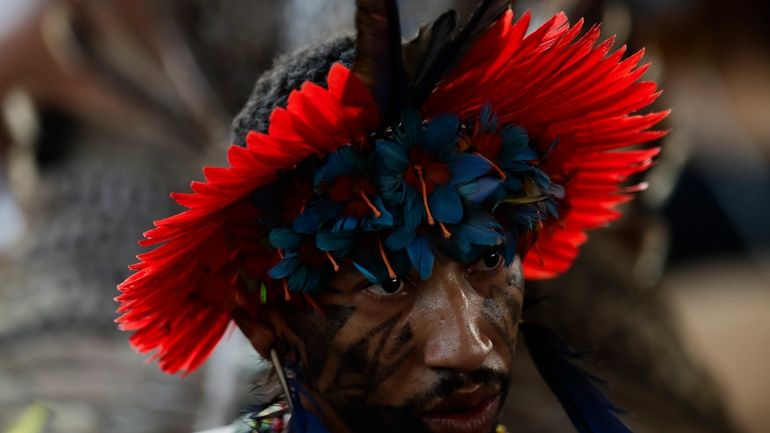 An Indigenous person attends a ceremony celebrating the return of...