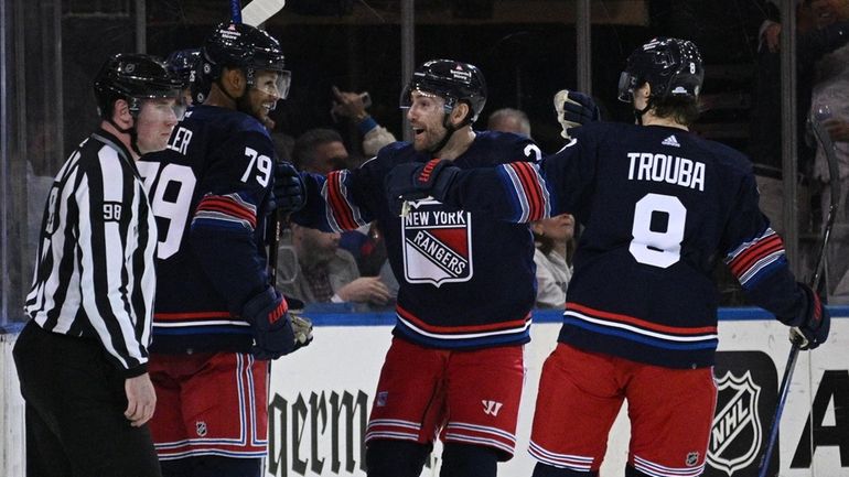 Rangers players celebrate a goal by left wing Jimmy Vesey...