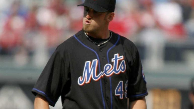 New York Mets starting pitcher Jonathon Niese looks into his...