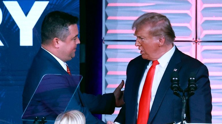 Republican Party of Florida chairman Christian Ziegler, left, greets former...