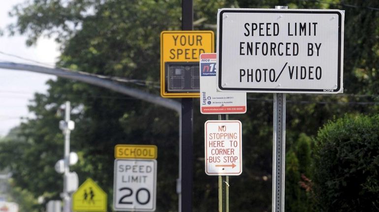 A sign warns motorists of a speed traffic camera in...